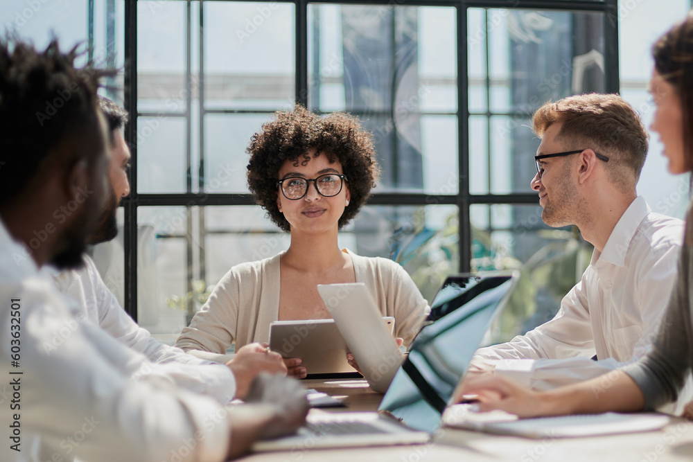 Fototapeta premium Employees working at computer together, discussing content