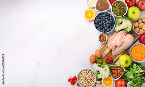 Fototapeta Naklejka Na Ścianę i Meble -  Fresh Ingredients for Dietary, Vegetables, Fruits, Nuts, Meat for Weight Loss on White Background