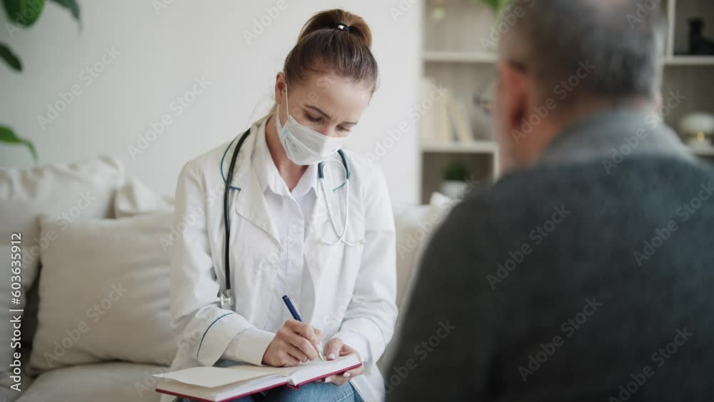 Empathic woman doctor holding notepad and laptop consulting senior man in modern private clinic. Medical practitioner ask questions, filling disease history form, provide help prescribe treatment. Empathic woman doctor holding notepad and laptop consulting senior man in modern private clinic. Medical practitioner ask questions, filling disease history form, provide help prescribe treatment.
