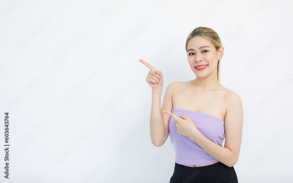 Portrait isolated cutout studio shot of Asian beautiful pretty cheerful female model in tube cropped top shirt smiling look at camera holding hands pointing fingers on copy space on white background Portrait isolated cutout studio shot of Asian beautiful pretty cheerful female model in tube cropped top shirt smiling look at camera holding hands pointing fingers on copy space on white background