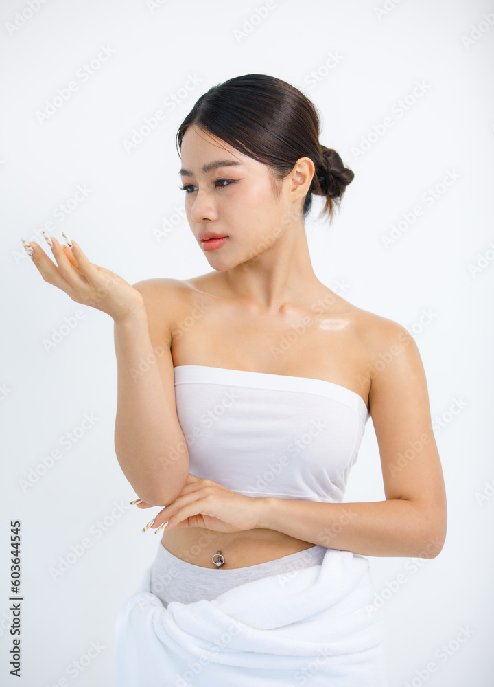 Isolated cutout studio shot Asian elegant glamour beautiful sexy female model in tube cropped top with belly button ring posing showing looking at hand with color painting nails on white background Isolated cutout studio shot Asian elegant glamour beautiful sexy female model in tube cropped top with belly button ring posing showing looking at hand with color painting nails on white background