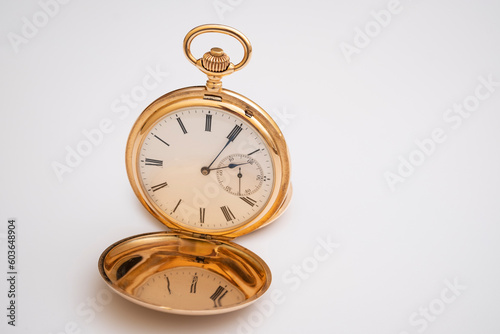 vintage gold pocket watch longines isolated on white background, pocket watch on books background