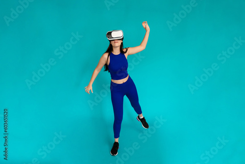 Woman with vr glasses simulating throwing a ball.
