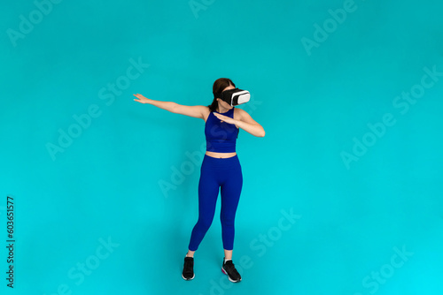 Woman with vr glasses simulating using bow and arrow.