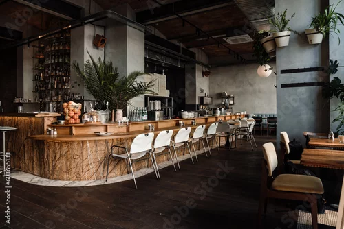 Fototapeta Modern interior in cafe with bar and chairs with concrete walls and wooden floor indoors