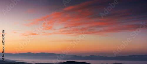 panorama of heavens at dawn. clouds in red and orange colors of a rising sun on a blue sky