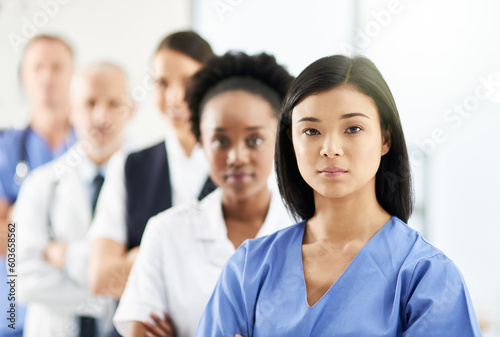 Teamwork, portrait of doctors and nurses in hospital, support and team work in healthcare. Health, diversity and medicine, serious woman doctor and group of medical employees standing in row together © Diane M/peopleimages.com