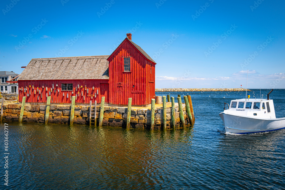 Red fishing shack and a trawler entering in Rockport Harbor, Cape Anne, Massachusetts Red fishing shack and a trawler entering in Rockport Harbor, Cape Anne, Massachusetts