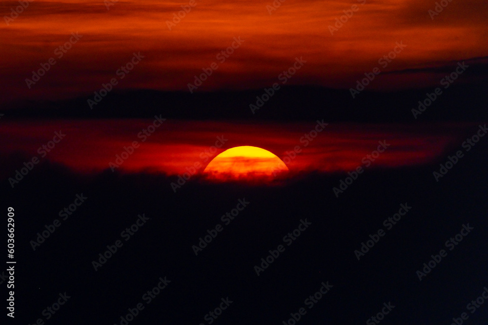 Deep orange sundown in sky at sunset.