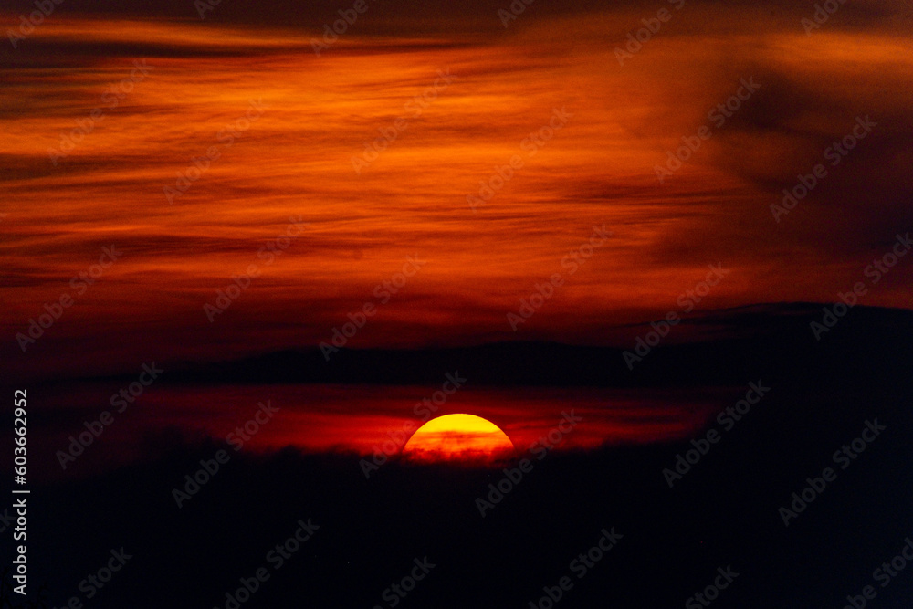 Deep orange sundown in sky at sunset.