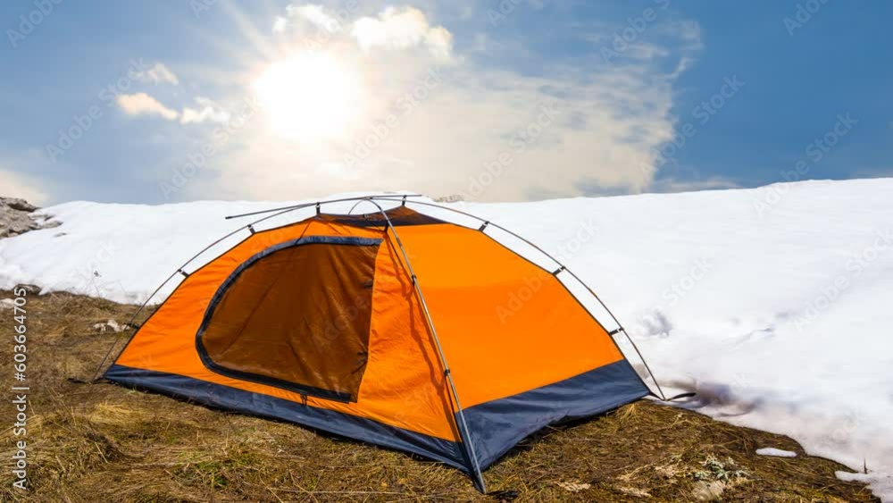 orange tent stay on the hill slope with snow under a sparkle sun, travel time lapse scene orange tent stay on the hill slope with snow under a sparkle sun, travel time lapse scene