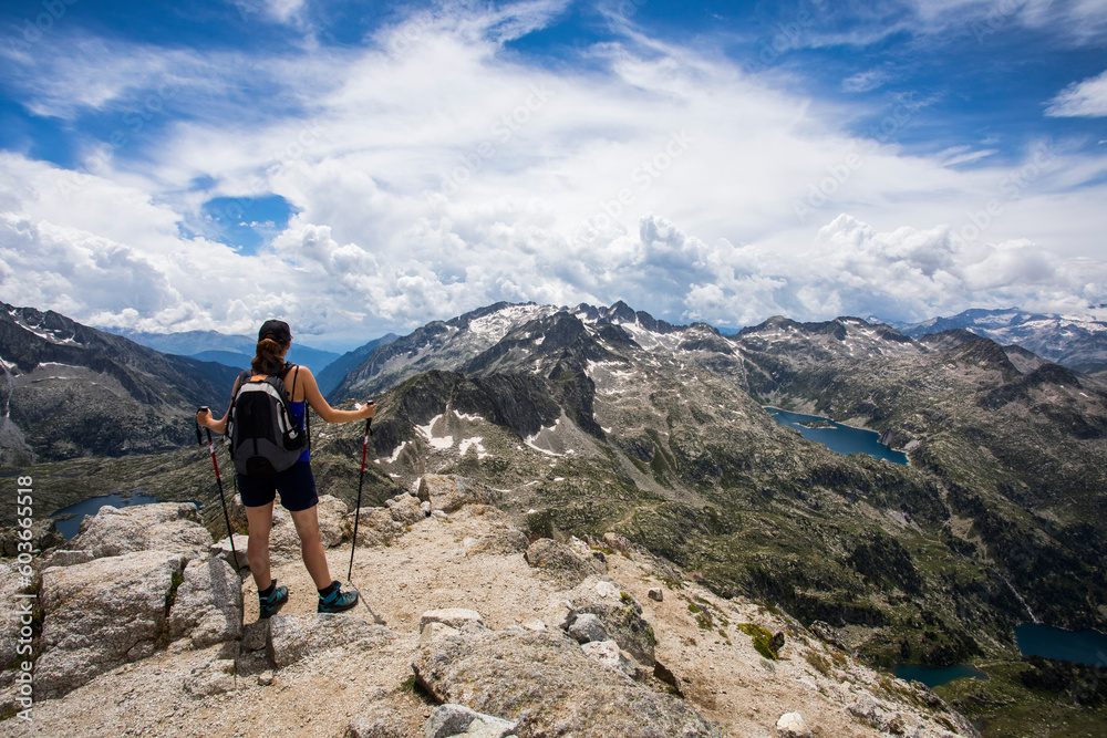 Young hiker girl summit to Montardo Peak in AIguestortes and Sant Maurici National Park, Spain