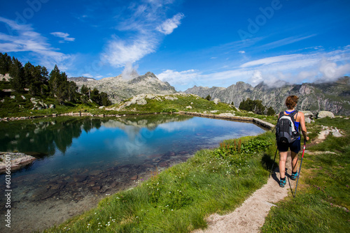 Young hiker girl summit to Montardo Peak in AIguestortes and Sant Maurici National Park, Spain