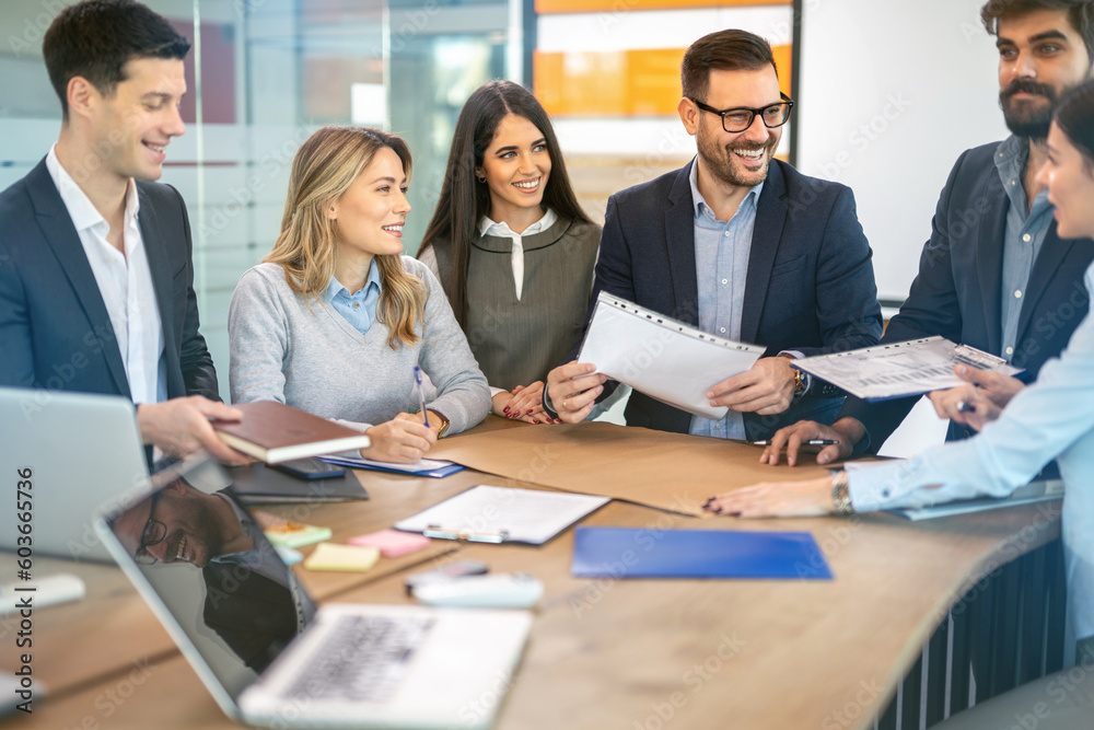 Group of multi ethnic business people analyzing together papers, reports, files, documents and records that are related to the various company activities on meeting in the office. Group of multi ethnic business people analyzing together papers, reports, files, documents and records that are related to the various company activities on meeting in the office.