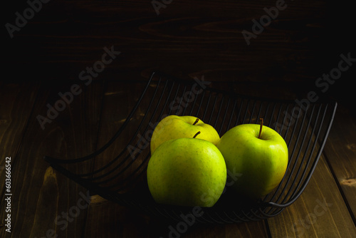 Fototapeta Naklejka Na Ścianę i Meble -  Bowl with green apples on dark wooden background