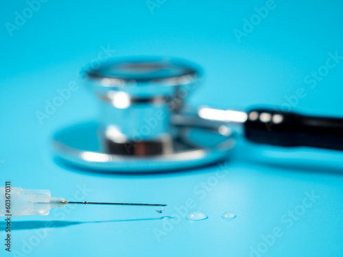 Injection vaccine on a blue background  medicine concept. On the syringe is applied  vaccination for adults and expiration date.