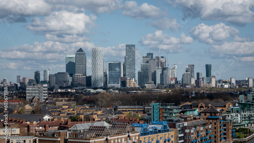 london Canary Wharf business district with residential buildings in the foreground on an overcast day. © microice