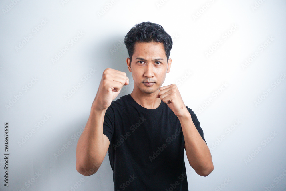 Come on let us fight. Portrait of excited self-assured arrogant male model, raising fists and standing in boxer pose, wanting to punch someone while drunk at pub over white wall Come on let us fight. Portrait of excited self-assured arrogant male model, raising fists and standing in boxer pose, wanting to punch someone while drunk at pub over white wall