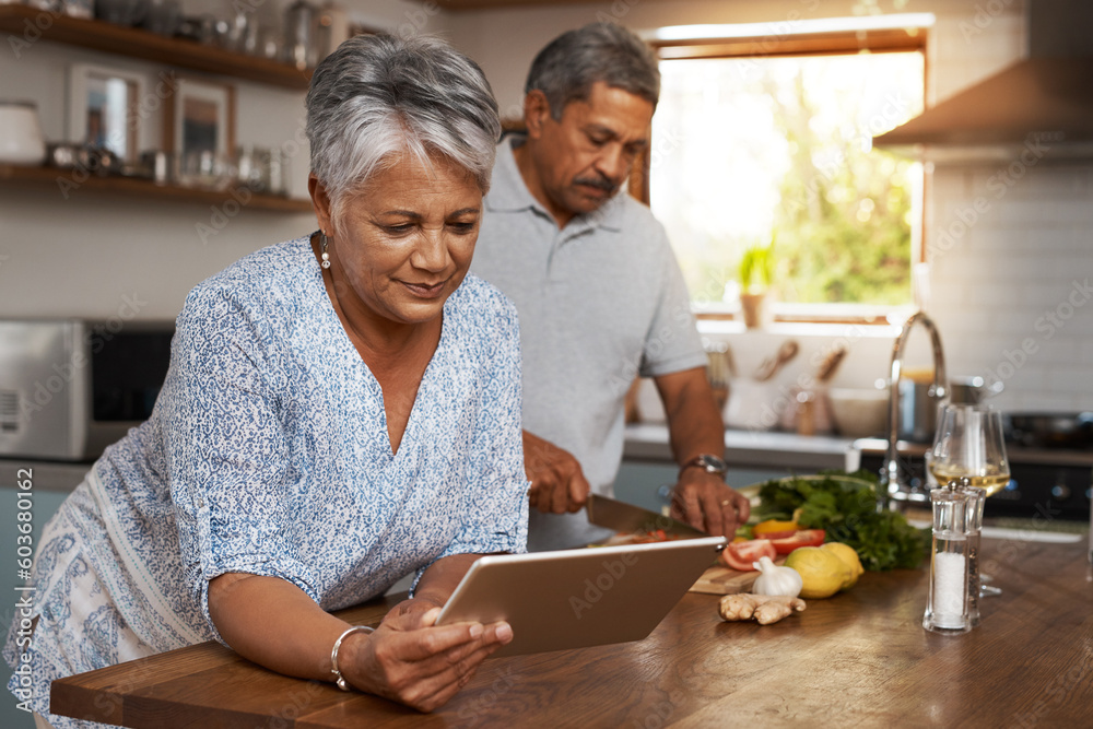 Senior couple, tablet and cooking in kitchen with healthy food, online search and app for nutrition in home. Digital recipe, old woman and man in house with meal prep, wellness and retirement diet. Senior couple, tablet and cooking in kitchen with healthy food, online search and app for nutrition in home. Digital recipe, old woman and man in house with meal prep, wellness and retirement diet.