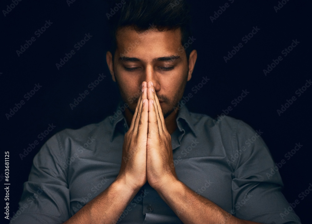 Night, worship and man with hands praying in studio to God, Jesus Christ or spiritual healing on black background. Holy, gratitude and thank you by christian male in prayer for help, hope and trust - obrazy, fototapety, plakaty 