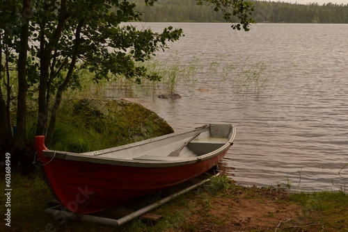 wooden boat on the lake shore  Finnish summer forest