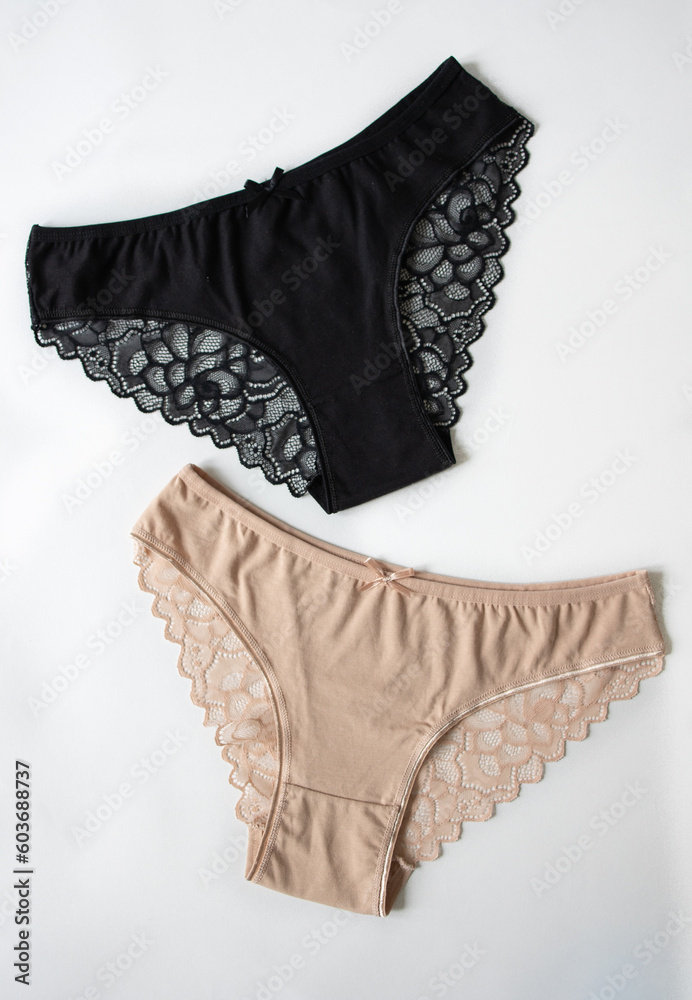 Flat lay casual underwear made of natural beige cotton, black panties with lace on a gray background. View from above. Concept: natural linen. Ecology, health, advertising, sale Flat lay casual underwear made of natural beige cotton, black panties with lace on a gray background. View from above. Concept: natural linen. Ecology, health, advertising, sale