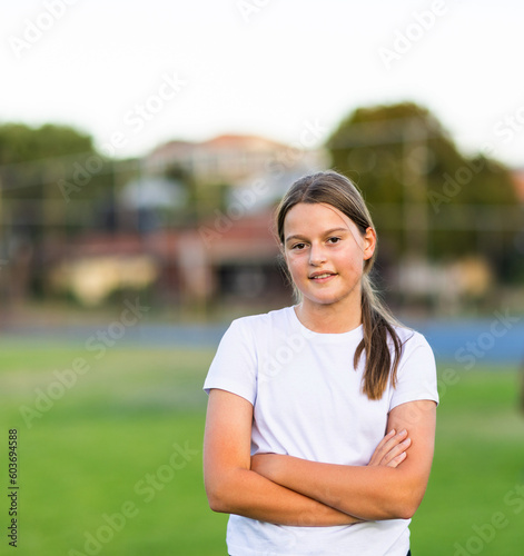 one tween girl with crossed arms looking at camera photo