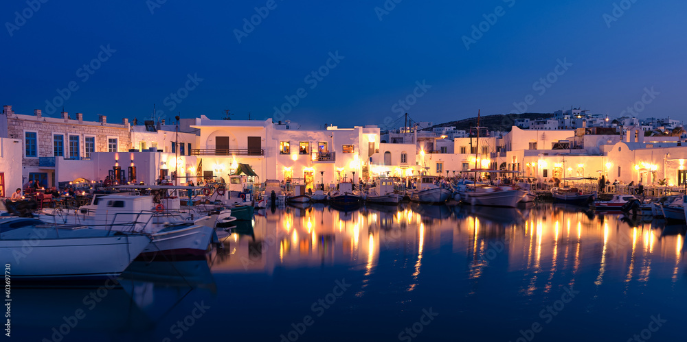 Traditional Greek fishing village and harbour after sunset, boats