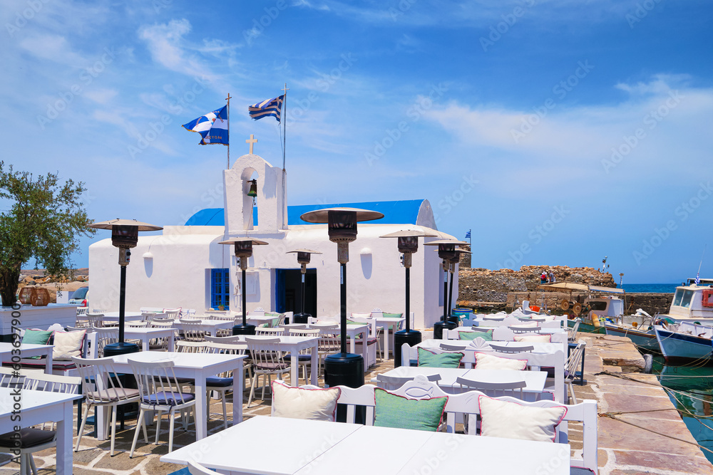 Outdoor dining by waterfront, fishing boat harbour of Naoussa, Paros
