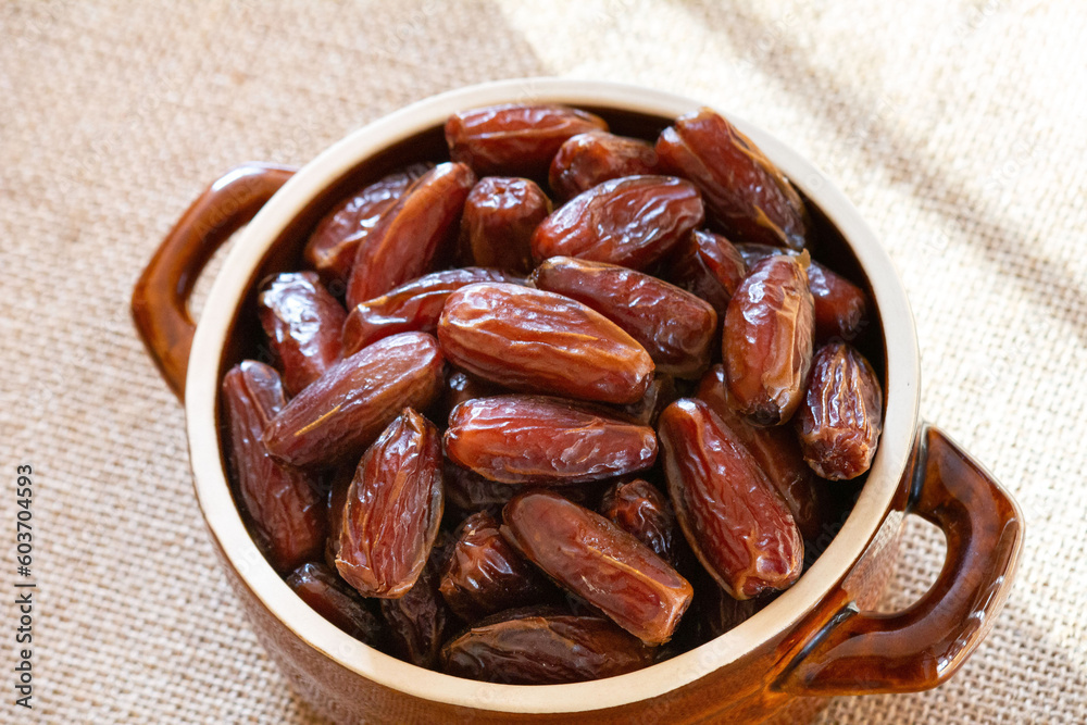 Dates in a brown dish Dates in a brown dish