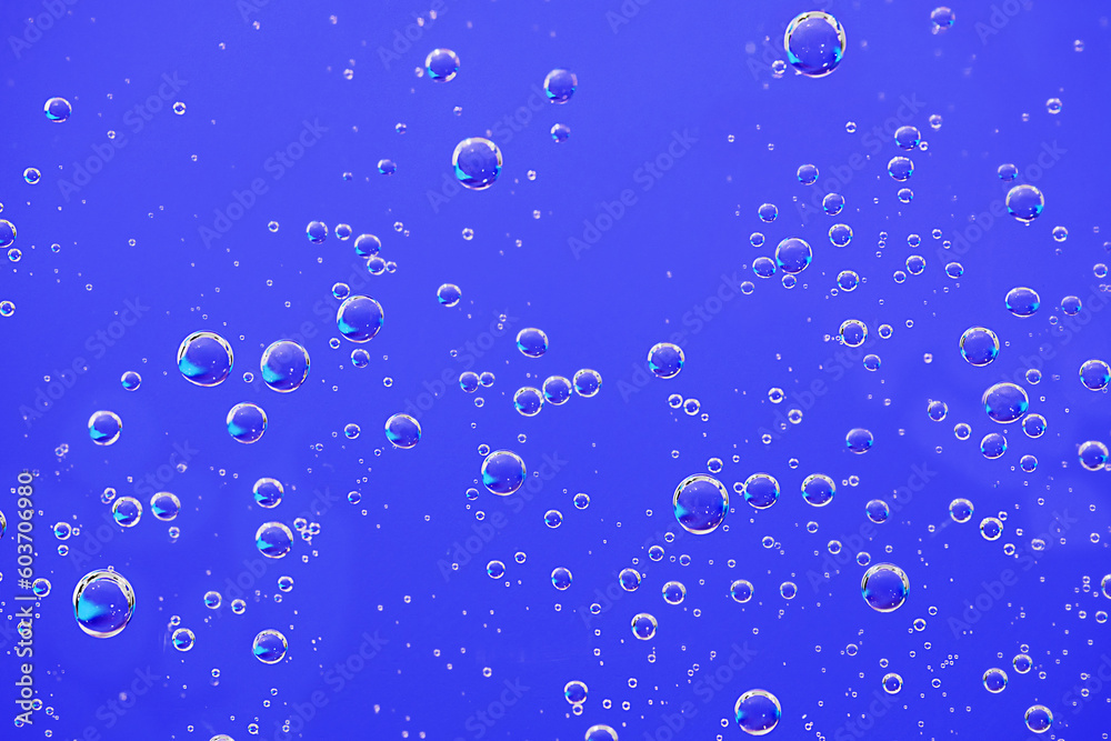 Water bubbles background. Macro oxygen bubbles in water over blue background.