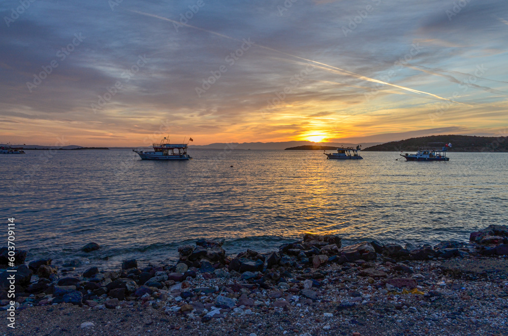 scenic view of Ildir Bay and Karabag Adasi island at sunset from Ildir pier (Cesme, Izmir province, Turkiye) scenic view of Ildir Bay and Karabag Adasi island at sunset from Ildir pier (Cesme, Izmir province, Turkiye)