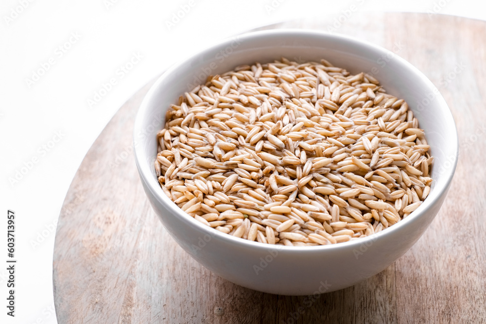 oat seeds in a round bowl isolated on wooden background top view oat seeds in a round bowl isolated on wooden background top view