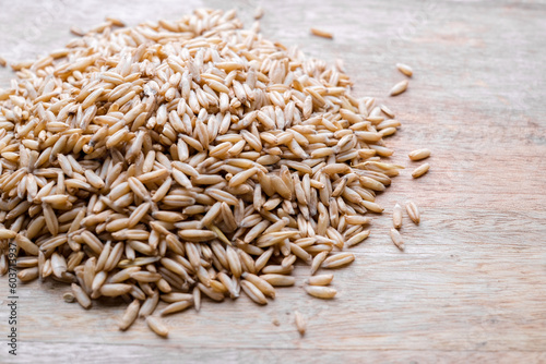 oat seeds heap isolated on wooden table background. top view with copyspace