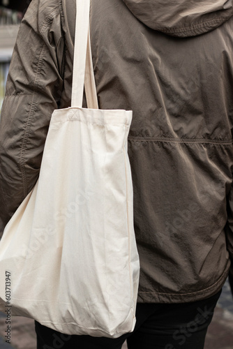 Tote bag on the shoulder. Person in the market.