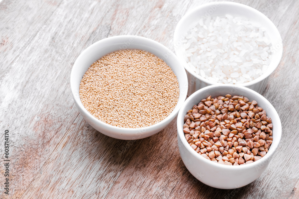Rice, buckwheat, amaranth seeds. Gluten free seeds in bowls. Top view with copyspace. Rice, buckwheat, amaranth seeds. Gluten free seeds in bowls. Top view with copyspace.