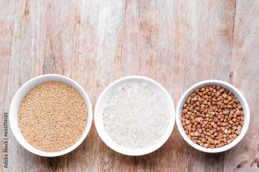 Rice, buckwheat, amaranth seeds. Gluten free seeds in bowls. Top view with copyspace. Rice, buckwheat, amaranth seeds. Gluten free seeds in bowls. Top view with copyspace.