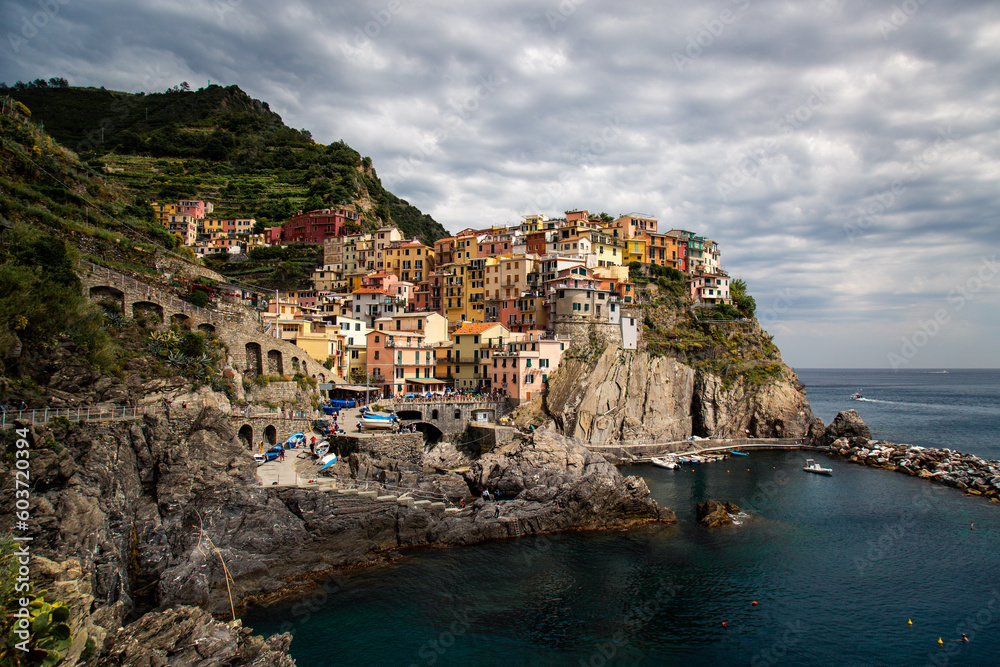Viewpoint of Manarola, in a cloudy day with its old buildings on the rock, Cinque Terre, Liguria, Italy