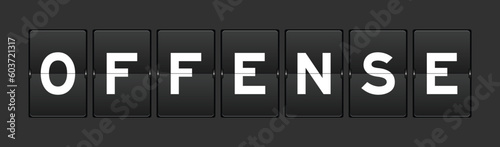 Black color analog flip board with word offense on gray background