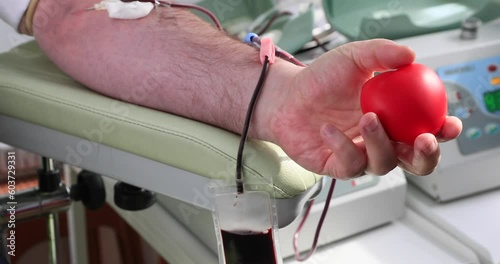 Health care and charity. Also a concept image of the background for World Blood Donor Day - 14 June..Man donating blood, close-up - test