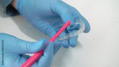 The dentist cleans his teeth with a toothbrush. Typodont, model of an artificial jaw. Dentistry dental clinic. Health care. Aligners