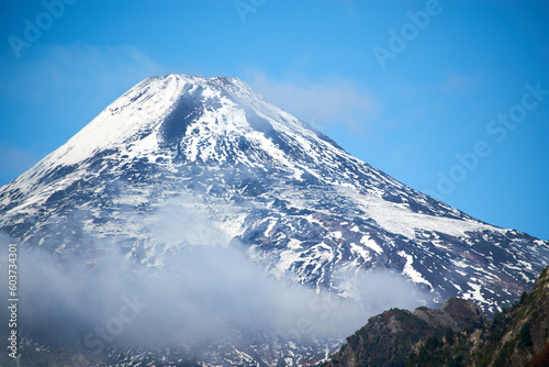 View of the Villarrica volcano during the autumn season with snow on its summit. © Alex