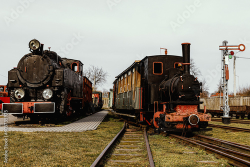 Classic steam engine at an open-air railway yard.
