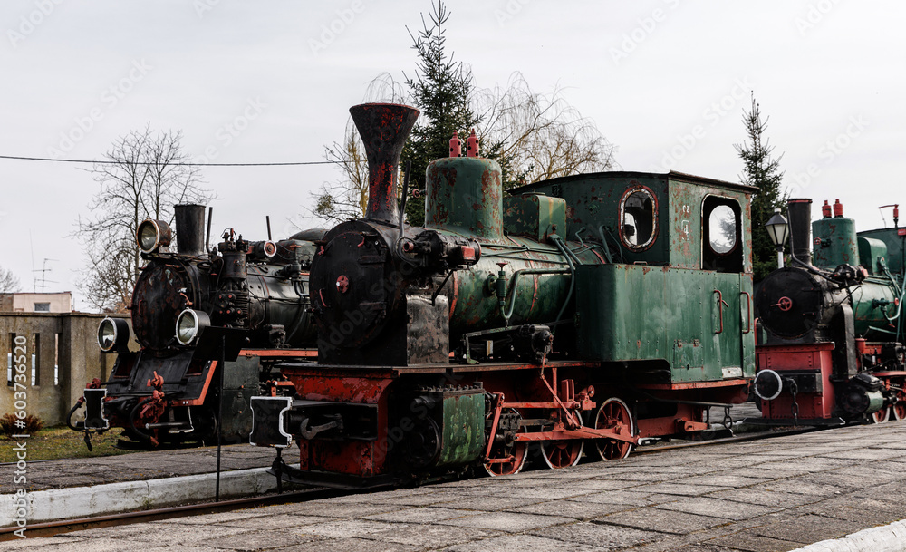 Naklejka premium Retro locomotive, steam train parked in an outdoor depot.