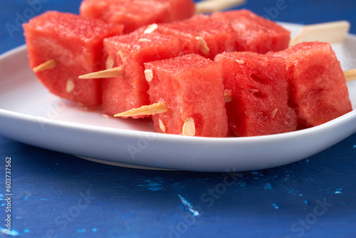 Finger food sticks with with watermelon cubes.