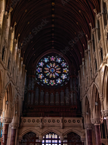 A large multicolored stained glass window in the Roman Catholic Church, city Cobh. The interior of Cathedral Church of St Colman.
