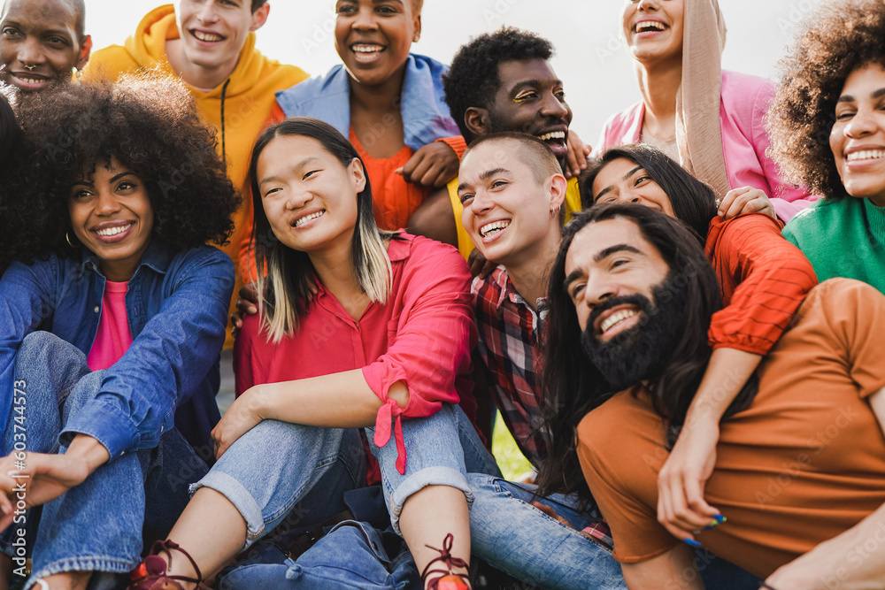 Obraz premium Group of happy young multiracial people having fun together at city park - Concept of diversity and friendship