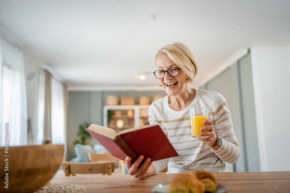 Senior woman mature caucasian female read book at home wear eyeglasses Senior woman mature caucasian female read book at home wear eyeglasses