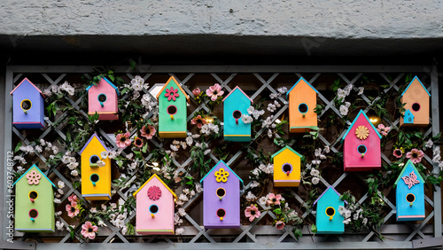 group of colorful wooden style birdhouse composition on the wall
