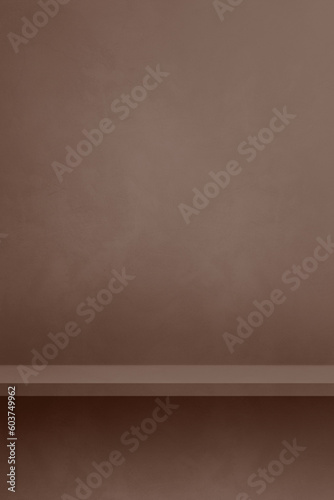 Empty shelf on a chocolate brown concrete wall. Background template. Vertical mockup